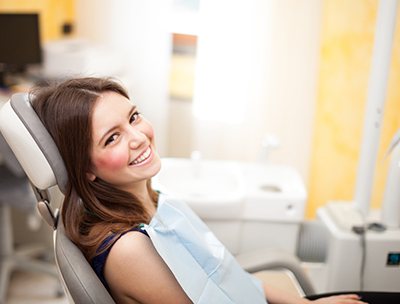 A woman visiting the dentist for a dental cleaning.