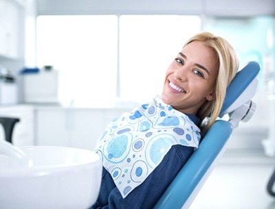 A female patient smiling in the dentist’s chair