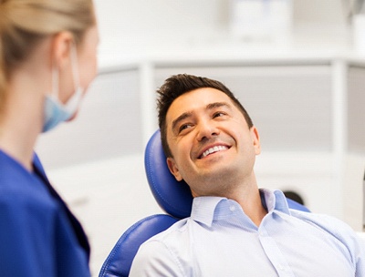 A male patient smiling at the dental hygienist