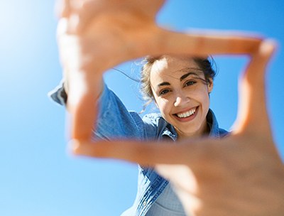 Woman framing her face with her fingers