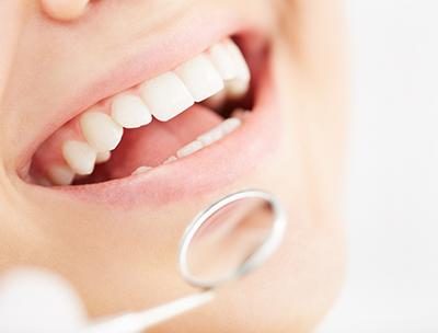 A person receiving a dental exam from a dentist.