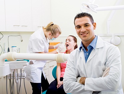 Two dentists serving a patient.