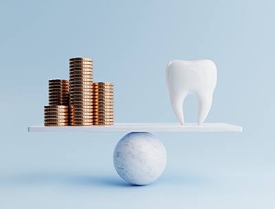 Tooth being balanced with some coins