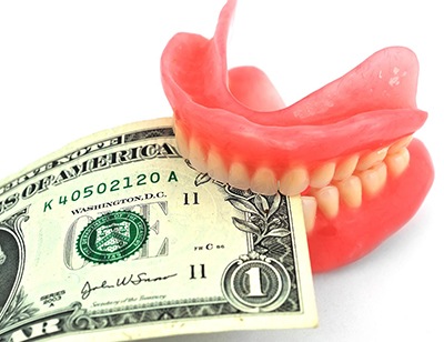 Dentures in Toledo holding dollar bills