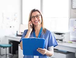 Receptionist holding dental paperwork