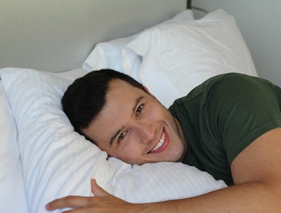 Man waking up well-rested thanks to sleep apnea therapy