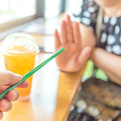 A person offering a straw while the other individual politely declines in Toledo