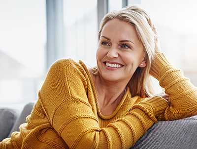 a woman smiling after getting a smile makeover in Toledo