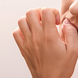 Closeup of patient biting their nails