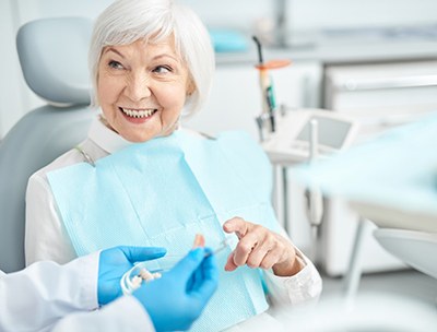 Patient smiling while talking to her dentist