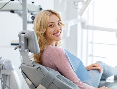 Woman smiling while sitting in treatment chair