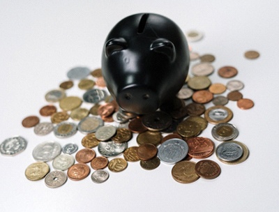 Black piggy bank and coins