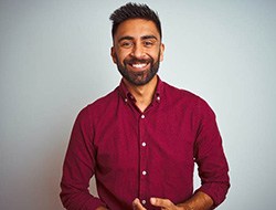 Closeup of man smiling in red shirt