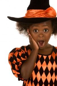 The family dentist Toledo trusts talks Halloween candy and cavities with this surprised child dressed as a witch