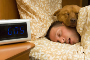 Man drooling with dog's head on his cheek