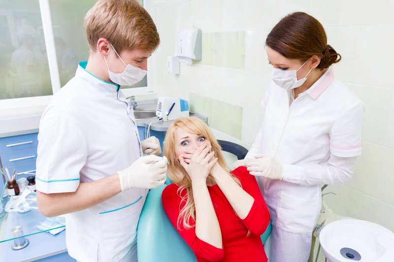 woman looking scared at dentist in Toledo