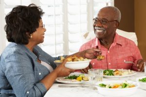 Man with dental implants in Toledo eating with wife