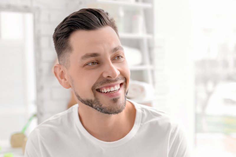 man smiling with dental implants in Toledo