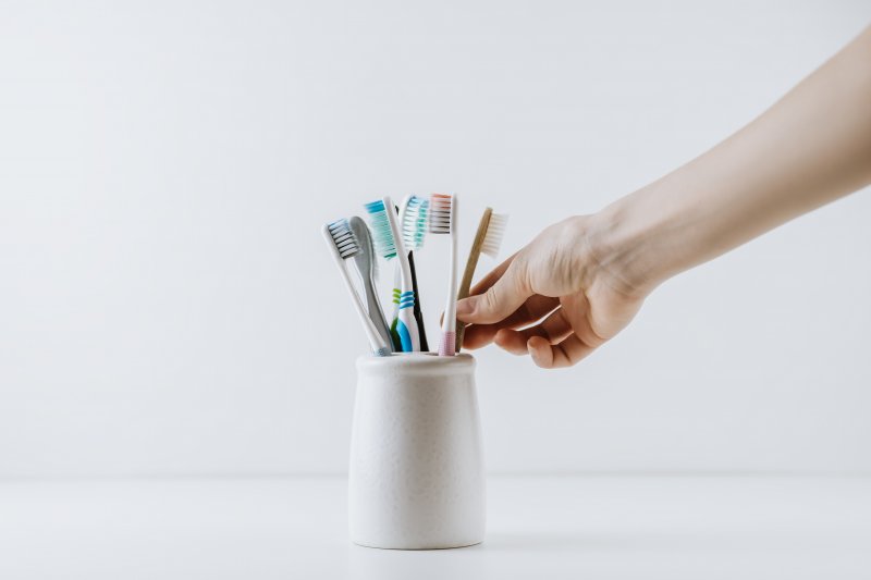 Hand reaches for toothpaste
