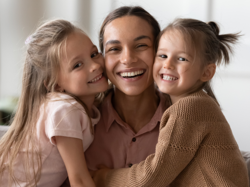 Mother and daughters, smiling