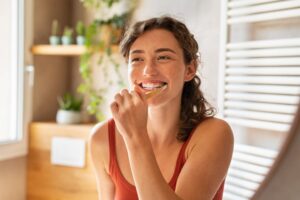 Young woman brushing her teeth.