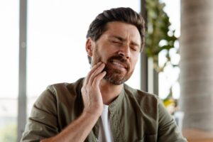 Man experiencing a TMJ flare-up
